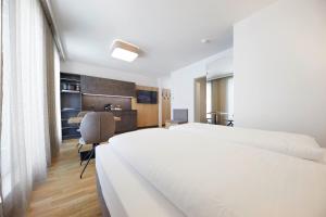 Ein Bett oder Betten in einem Zimmer der Unterkunft Hotel Gösser Bräu