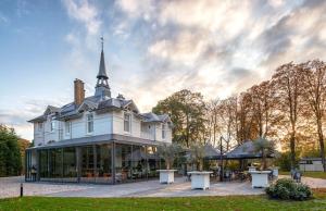 a large white house with a spire on top at Boutiquerooms WesterVilla Amsterdam in Amsterdam
