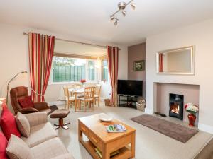 a living room with a couch and a fireplace at Berrymoor Cottage in Brampton