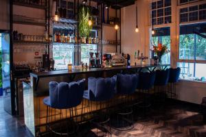 a bar with blue bar stools in a room at Boutiquerooms WesterVilla Amsterdam in Amsterdam