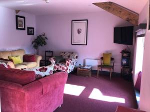 a living room with two couches and a tv at Lady Charlotte's Loft in Schull