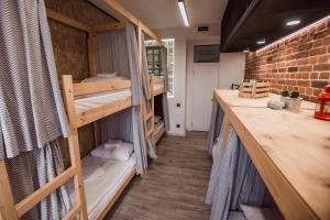 a room with bunk beds and a brick wall at Хостел LOFT in Belgorod