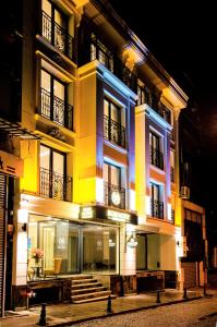 a building is lit up at night at Boss Hotel Sultanahmet in Istanbul