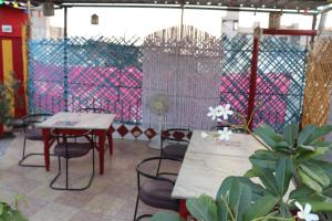 a patio with tables and chairs and a fence at Govind Hotel in Jodhpur