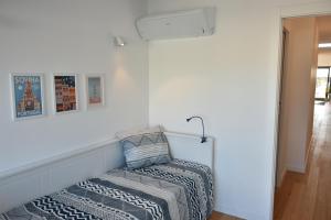 a bed sitting on the side of a wall at Sunny Penthouse whith balcony 9min walk main station in Porto