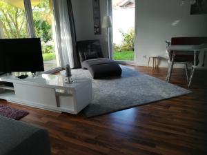 a living room with a couch and a tv and a table at Ferienwohnung Drabinski in Kiel