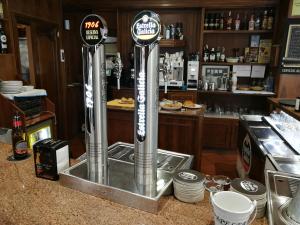 a bar with two water dispensers on a counter at H. O Lar in O Barco de Valdeorras