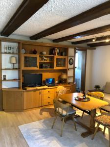 a living room with a table and a television at APARTMENT CLUBHOTEL in Seefeld in Tirol