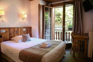 Кровать или кровати в номере Le Dahu