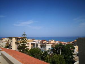 a view of the ocean from a city at Residence VILLA FIORITA in Roccella Ionica