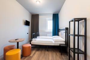 Ένα ή περισσότερα κρεβάτια σε δωμάτιο στο a&o Stuttgart City