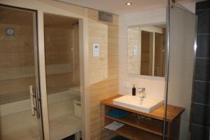 a bathroom with a sink and a shower at Biobauernhof Jagglhof in Saalfelden am Steinernen Meer +42 photos