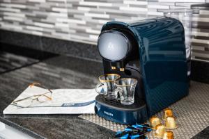 a coffee maker sitting on a counter with two cups at Calpe Beach in Calpe