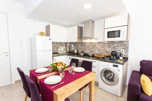 a kitchen with a table and a kitchen with a washing machine at Calpe Beach in Calpe