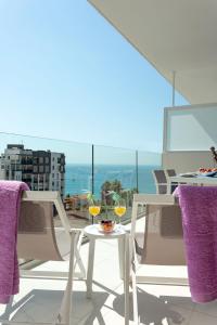 a table and chairs with wine glasses on a balcony at Calpe Beach in Calpe