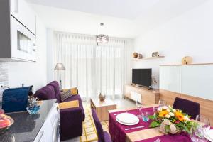 a living room with a couch and a table with flowers on it at Calpe Beach in Calpe