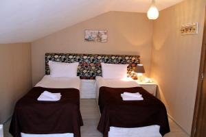 a small room with two beds and a table at Hotel New Metekhi in Tbilisi City