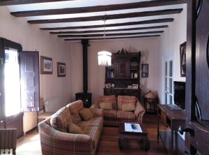 a living room with two couches and a table at Casa Rural El Granero in Treviana