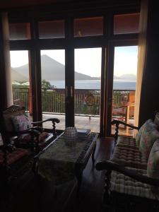 a living room with a table and a large window at Villa Ma'Rasai in Ternate