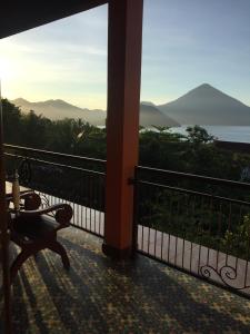 a balcony with a bench and a view of the mountains at Villa Ma'Rasai in Ternate