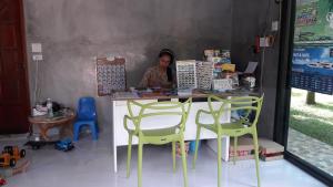 a woman sitting at a counter in a food cart at Fill - Feel @ Long Beach Resort in Ko Lanta
