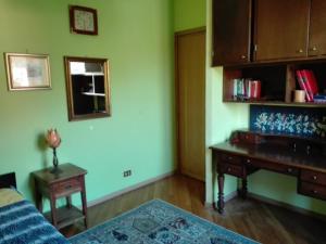 a living room with a table and a piano at La Torretta bed & breakfast in Torriglia
