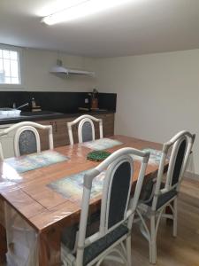 a dining room table with four chairs around it at T1 Dans Maison Au Calme in Réalmont +9 photos