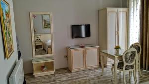 a living room with a table and a mirror at Hotel Guri in Elbasan +45 photos