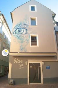 a building with a painting of an eye on it at Haus Renè in Villach