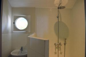 a bathroom with a shower and a sink at Le Petit Couvent in Musculdy