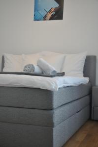 a bed with white sheets and towels on it at 4 Beds and More Vienna Apartments - Contactless check-in in Vienna