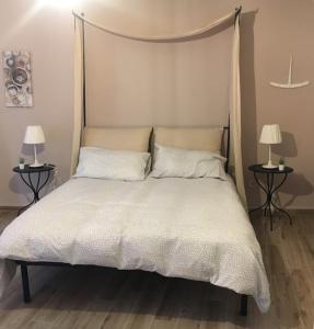 1 cama en un dormitorio con 2 lámparas en las mesas en IL PANARO, en Palermo