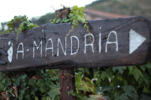 a wooden sign that reads a manana is at A MANDRIA, appartements avec cuisine 30m2, patio, vue Montagnes et citadelle, 5 minutes à pied du centre ville et des rivières in Corte