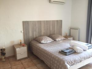 a bedroom with a bed with two pillows on it at Charmant rez de villa en provence in Le Tignet +33 photos