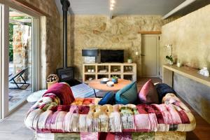 a living room with a couch and a table at Umami Mountain Retreat in Franschhoek