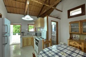 a kitchen with a table and a stove top oven at Secret Sporades Panoramic Residence in Klíma