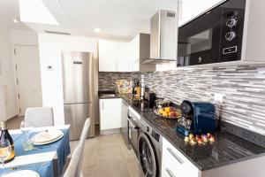 a kitchen with a counter top with a dishwasher at Calpe Beach in Calpe