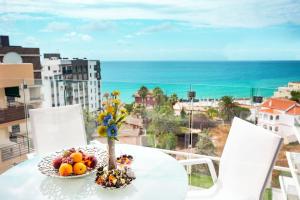 a table with a bowl of fruit on top of a balcony at Calpe Beach in Calpe