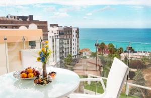 a table with a bowl of fruit on a balcony at Calpe Beach in Calpe