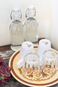 a table with three glass containers on a plate at Baan Boon in Bangkok