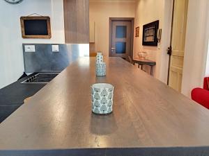 a kitchen with a wooden table with a glass on it at Nestor&Jeeves - DALPOZZO GRANDE - Central - Close beaches in Nice