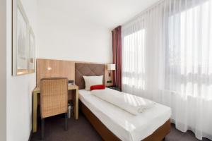 Postel nebo postele na pokoji v ubytování ACHAT Hotel München Süd