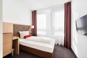 Postel nebo postele na pokoji v ubytování ACHAT Hotel München Süd
