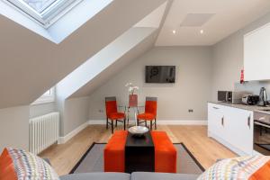 a kitchen and living room in a loft with a table and chairs at Destiny Scotland Hanover Apartments in Edinburgh