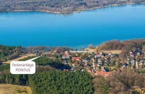 arial view of a small town with a lake at PONTUS Ferienwohnung FeWo2 in Zislow