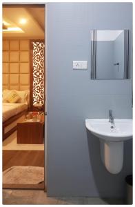 a bathroom with a sink and a bed at Empark in Bengaluru