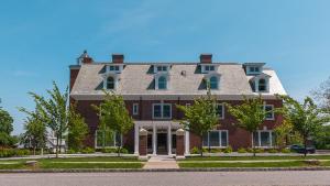 a large red brick house with a roof at The George in Montclair