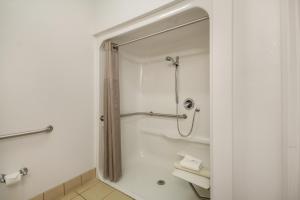 a bathroom with a shower and a toilet in it at Howard Johnson by Wyndham Lemoore Near Naval Air Station in Lemoore +14 photos