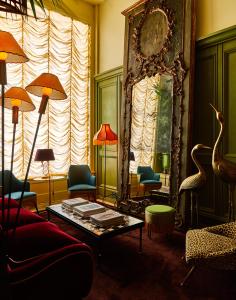 a living room with a couch and a mirror at The Siren Hotel in Detroit