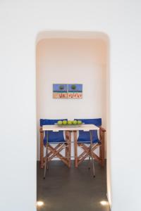 a dining room with a table with fruit on it at Lava Caves in Oia
